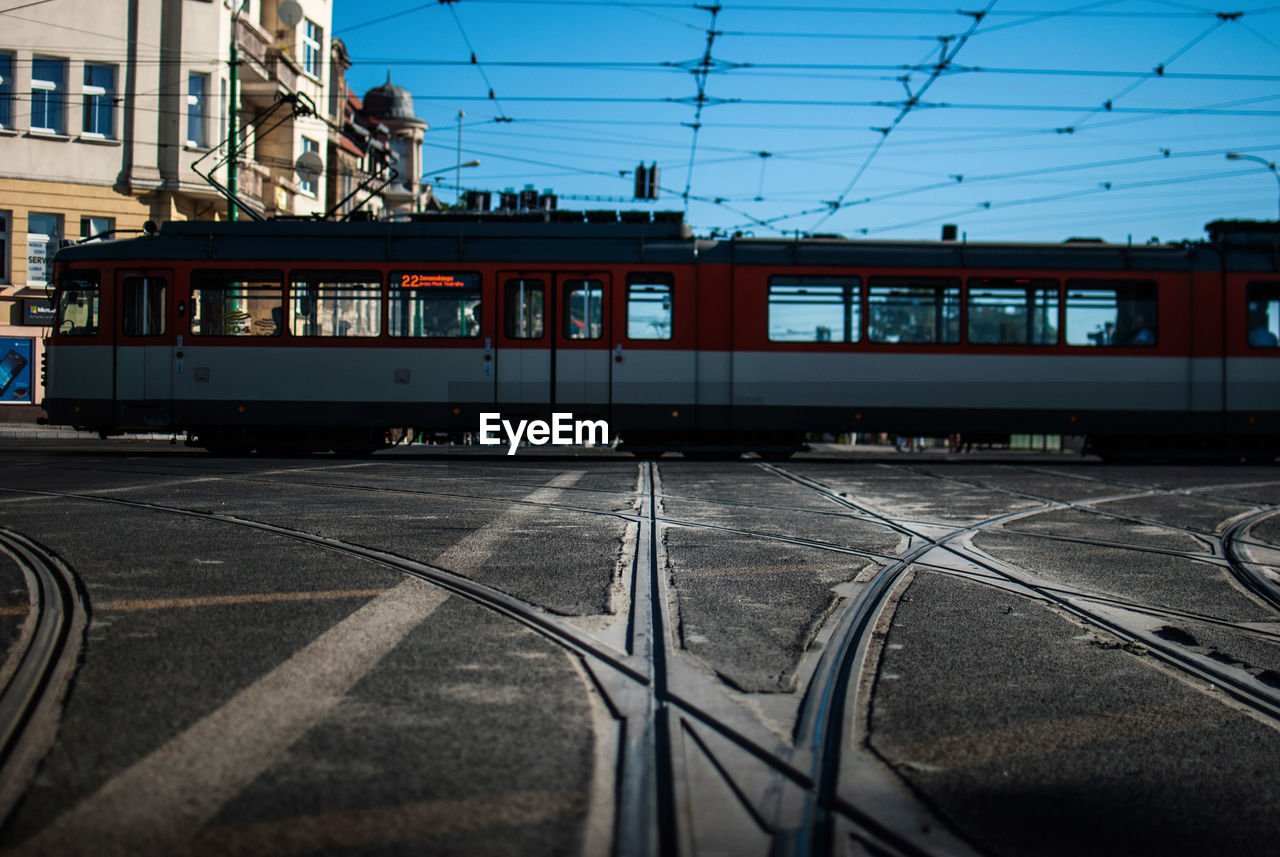 Tram on track against blue sky