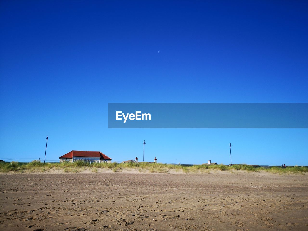 Scenic view of land against clear blue sky