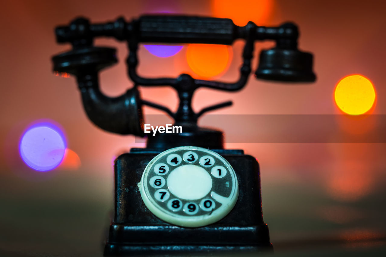 Close-up of telephone on table