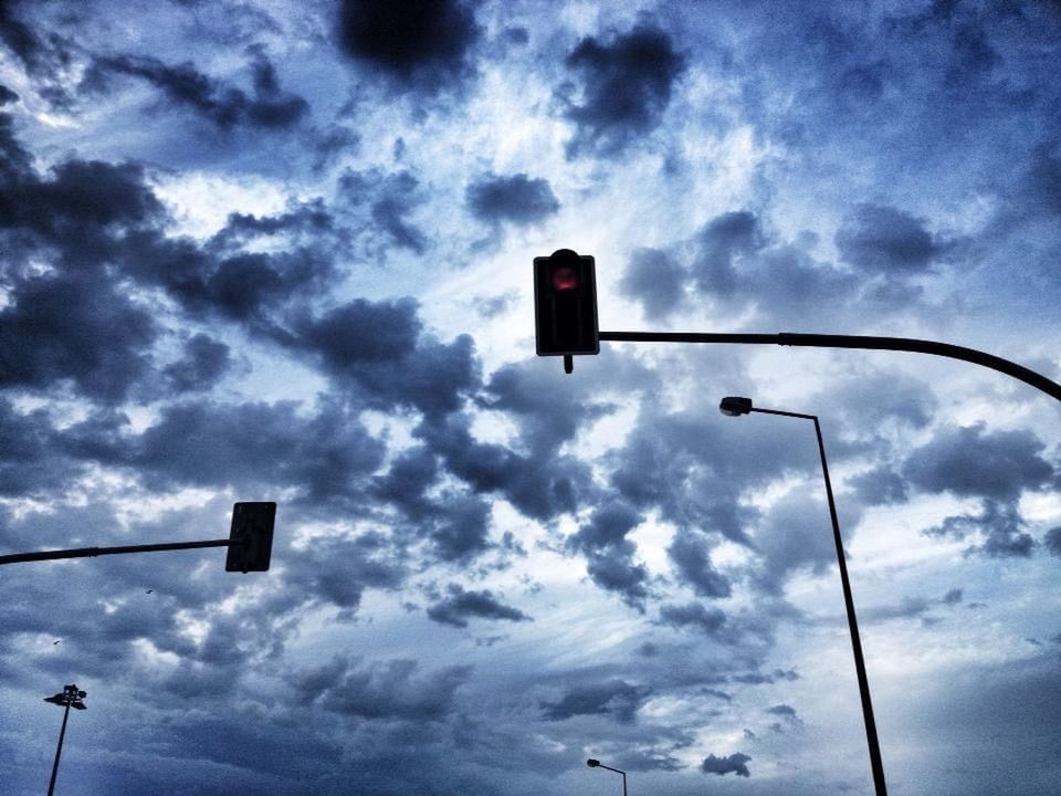 sky, cloud, stoplight, street light, road signal, traffic light, street, light, sign, low angle view, lighting equipment, red light, guidance, signaling device, light fixture, road sign, road, nature, green light, no people, city, transportation, communication, lighting, outdoors, silhouette, dusk, control, illuminated, darkness, line, blue, symbol, overcast, day, pole, traffic