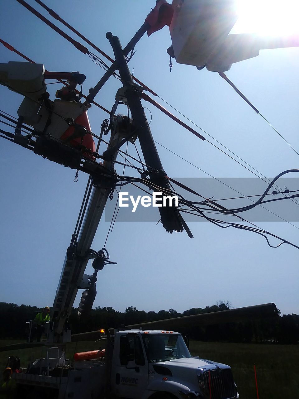 LOW ANGLE VIEW OF ELECTRICITY PYLON IN CITY