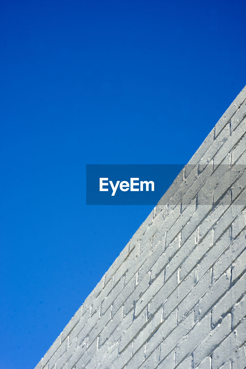 Low angle view of building against clear blue sky