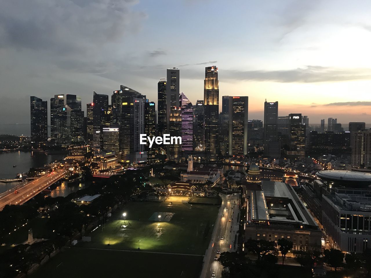 High angle view of illuminated city buildings against sky