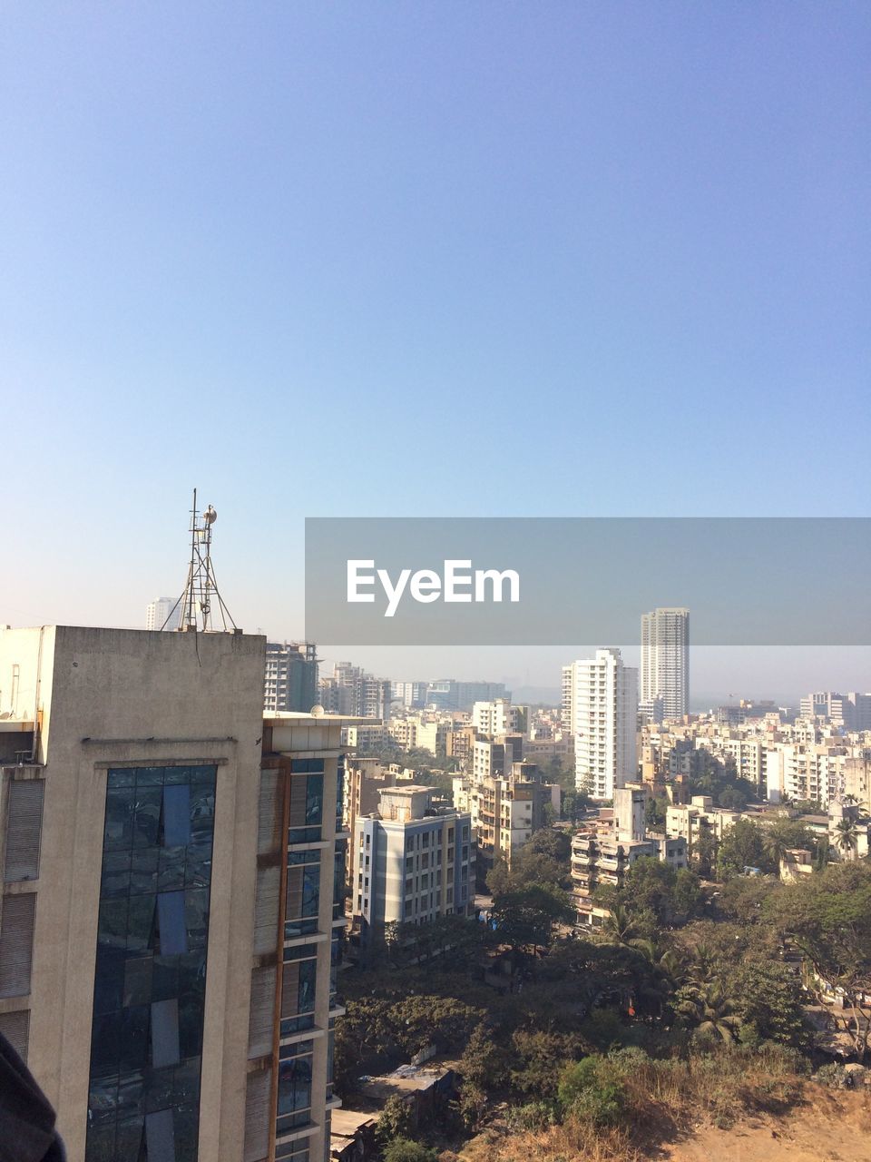 Buildings against clear sky on sunny day