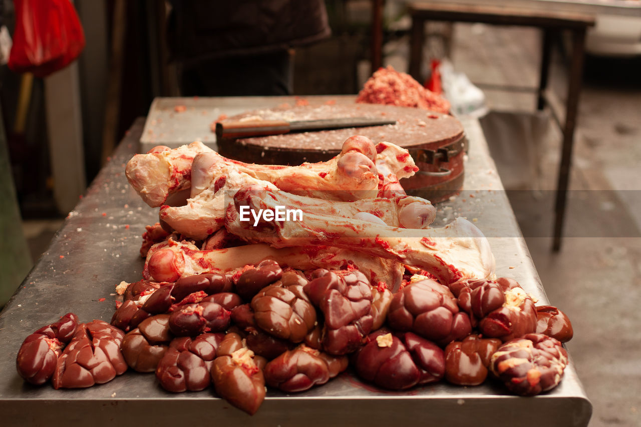 Kidneys and bones on a butcher's bench in xian wet market.