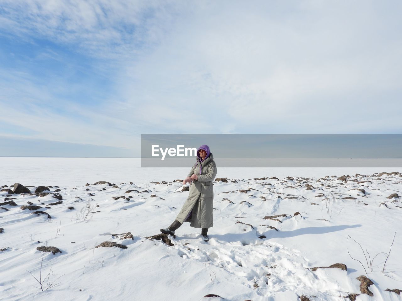 Woman standing on frozen sea