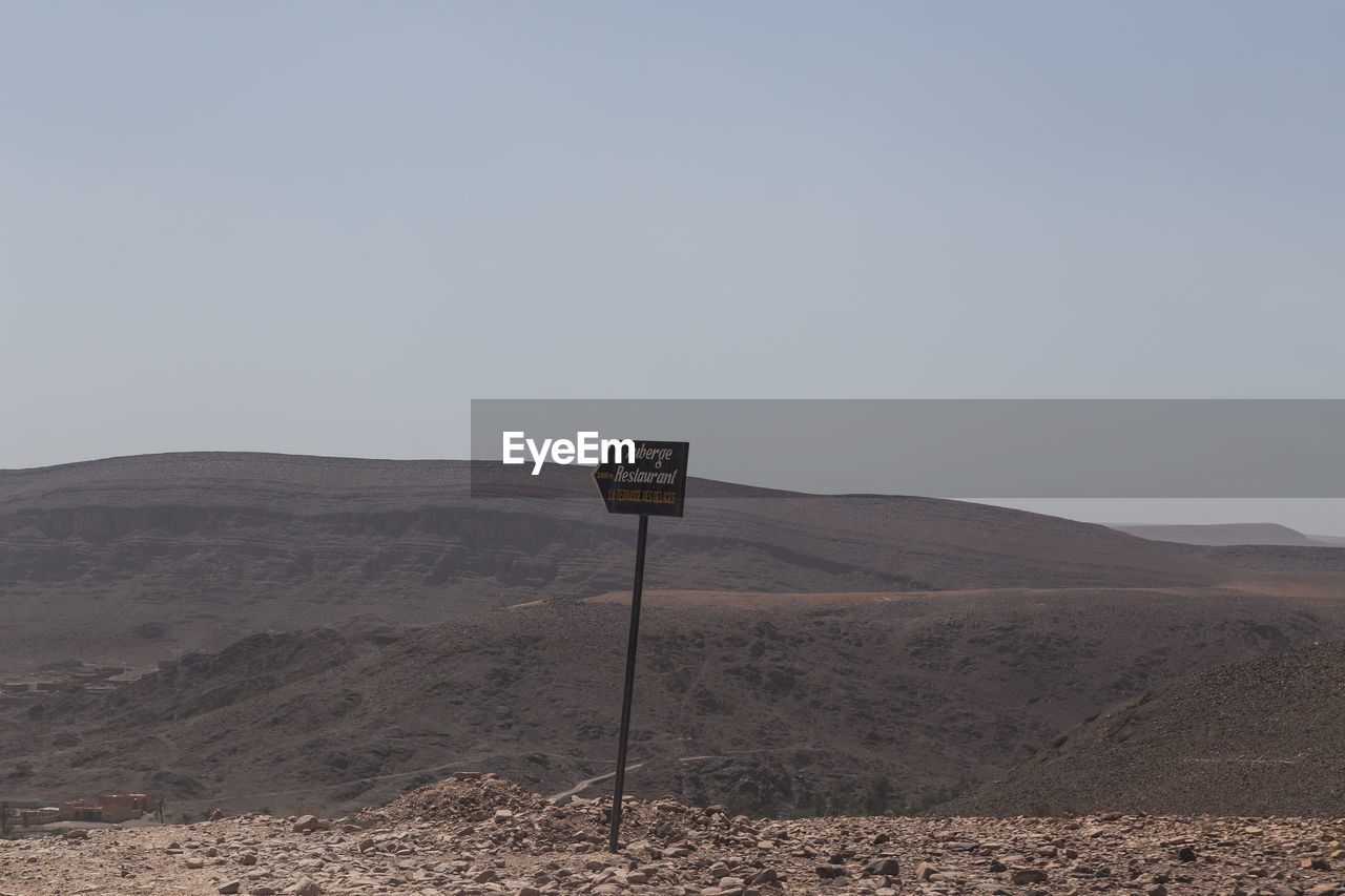INFORMATION SIGN IN DESERT AGAINST SKY