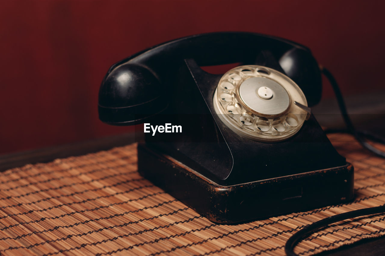 Close-up of old telephone on table