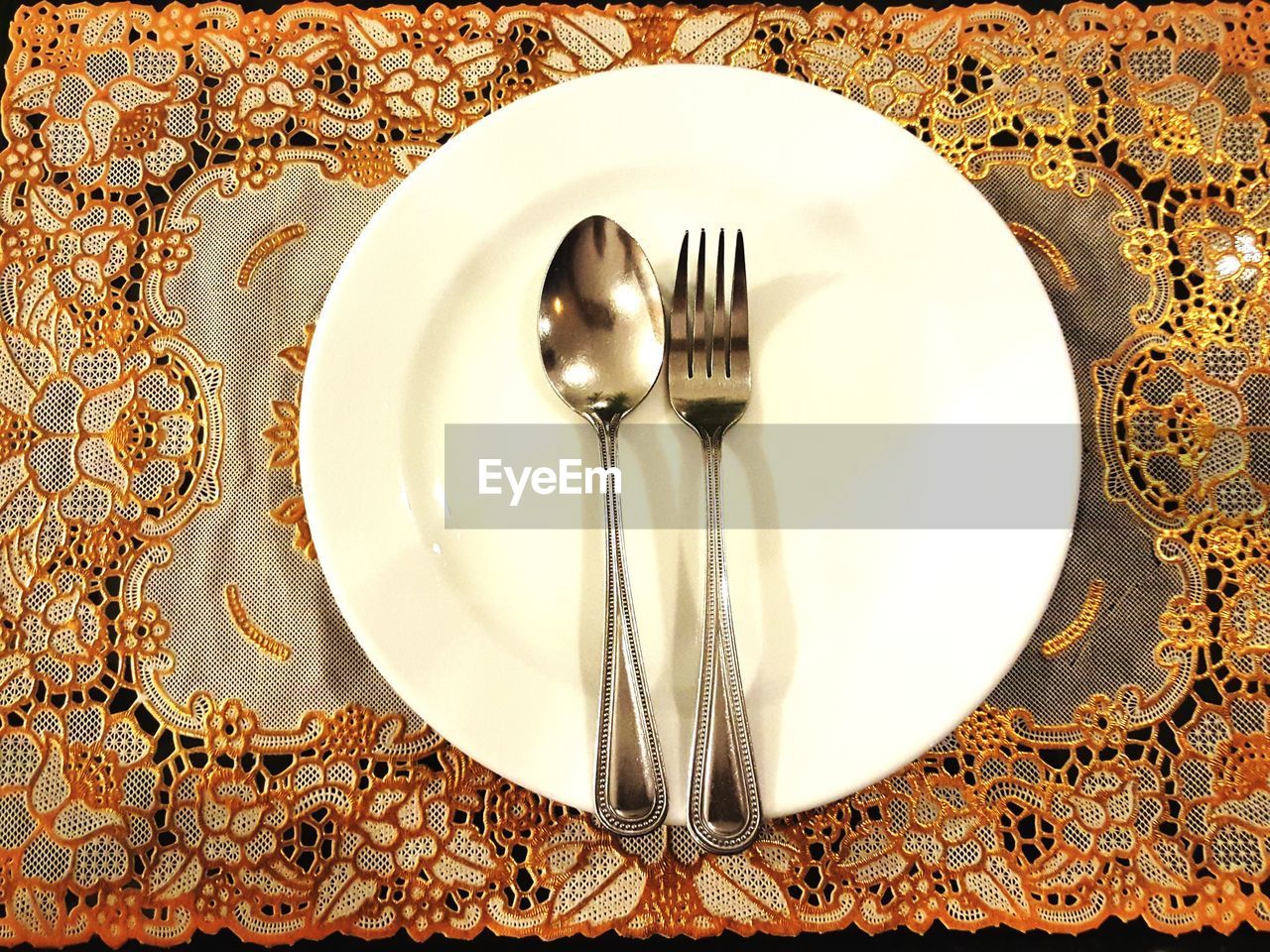High angle view of cutlery on place mat
