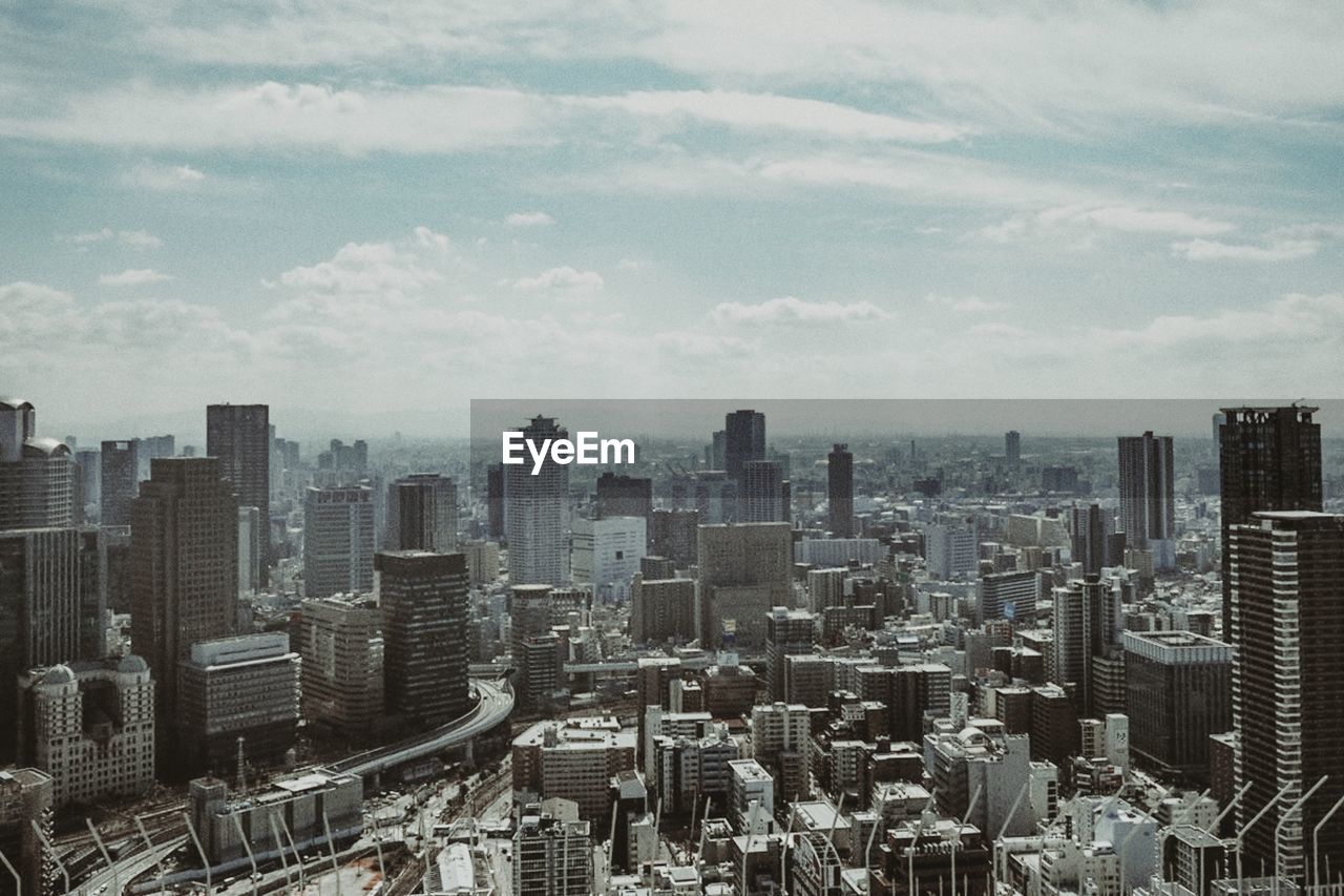 Aerial view of modern buildings in city against sky