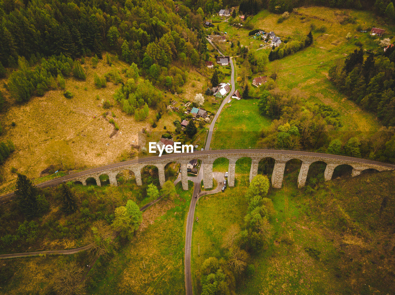 High angle view of rail bridge over road amidst trees