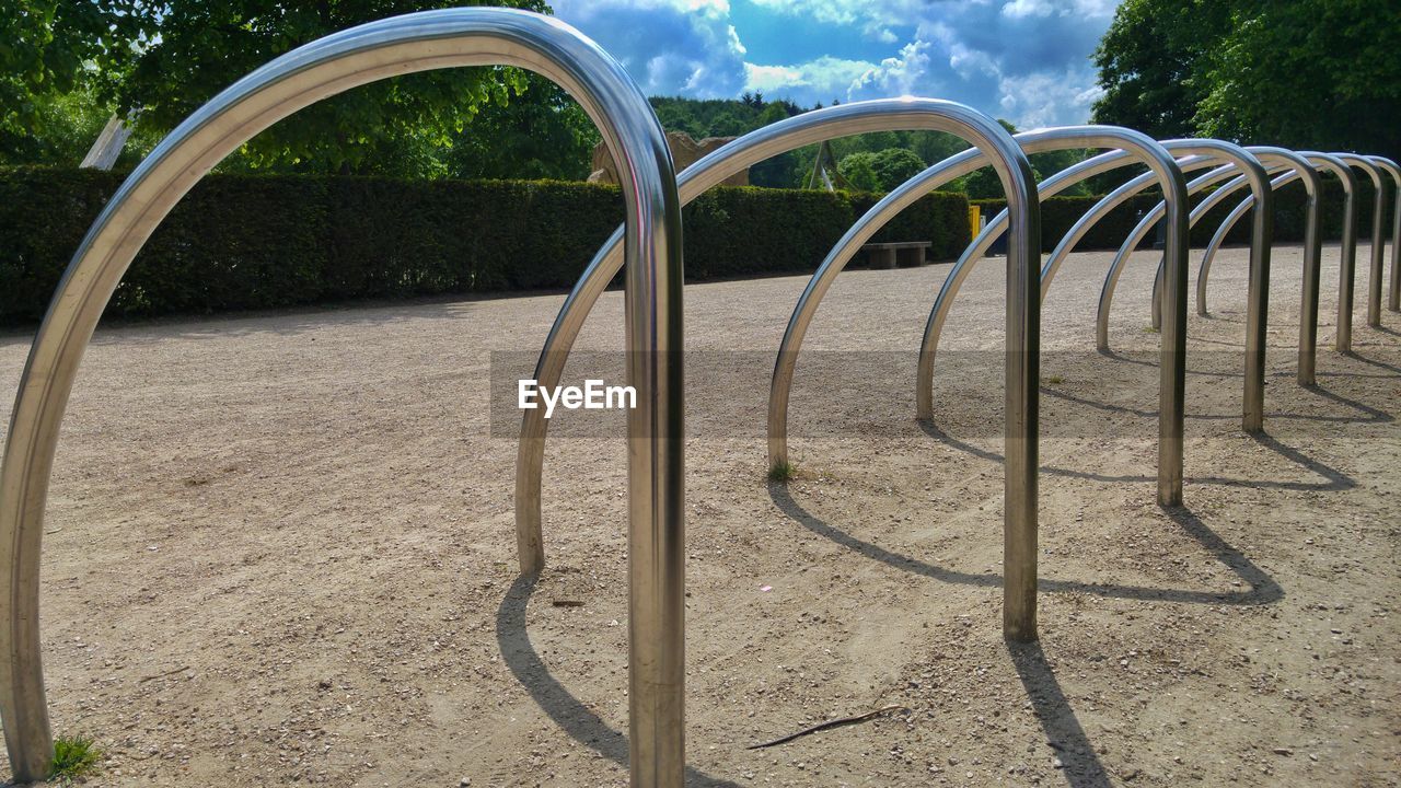 Bicycle racks at park on sunny day