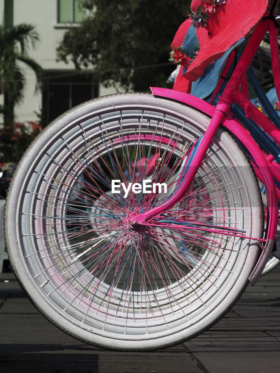 CLOSE-UP OF BICYCLE WITH PINK BASKET