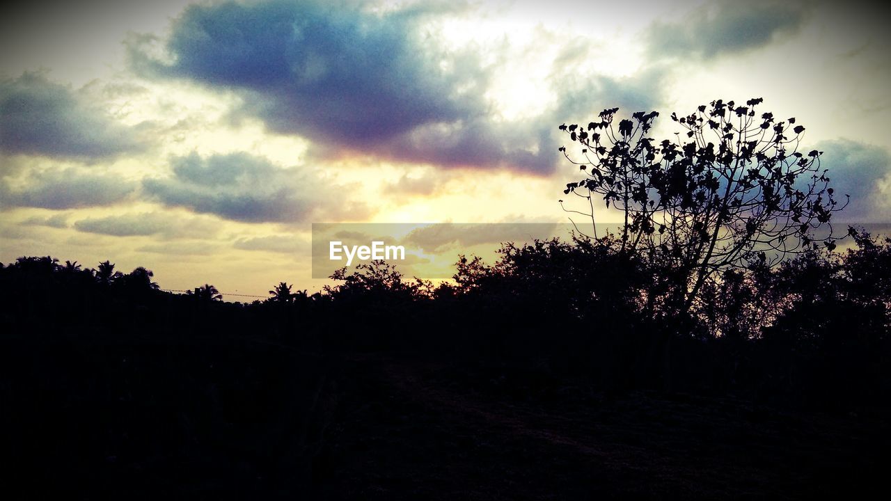 Silhouette of landscape against cloudy sky