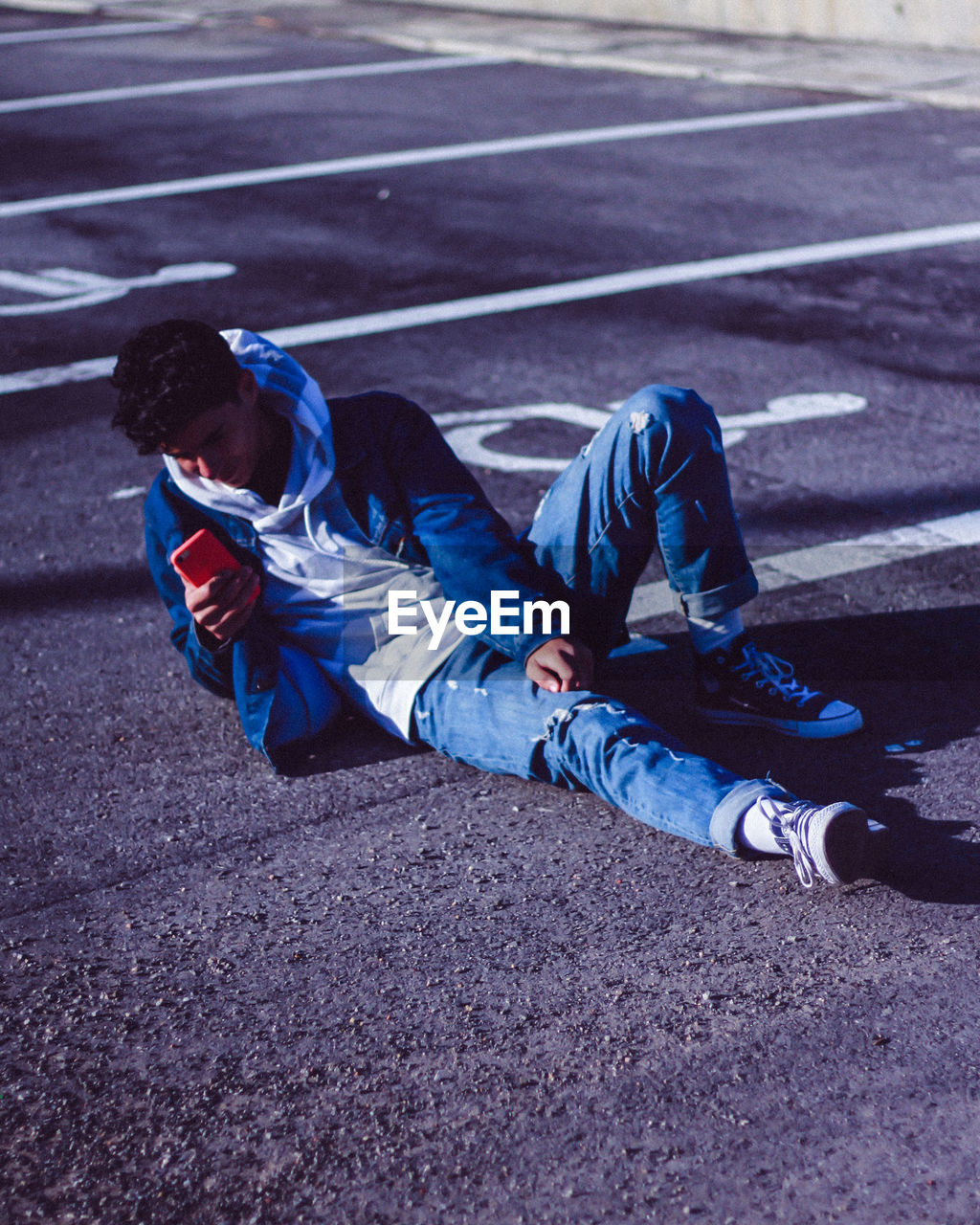 HIGH ANGLE VIEW OF MAN LYING ON STREET