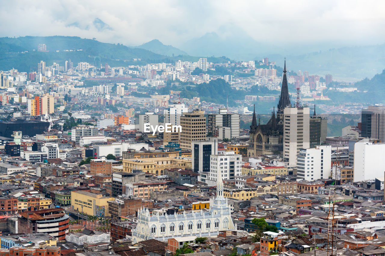 High angle view of cityscape against cloudy sky