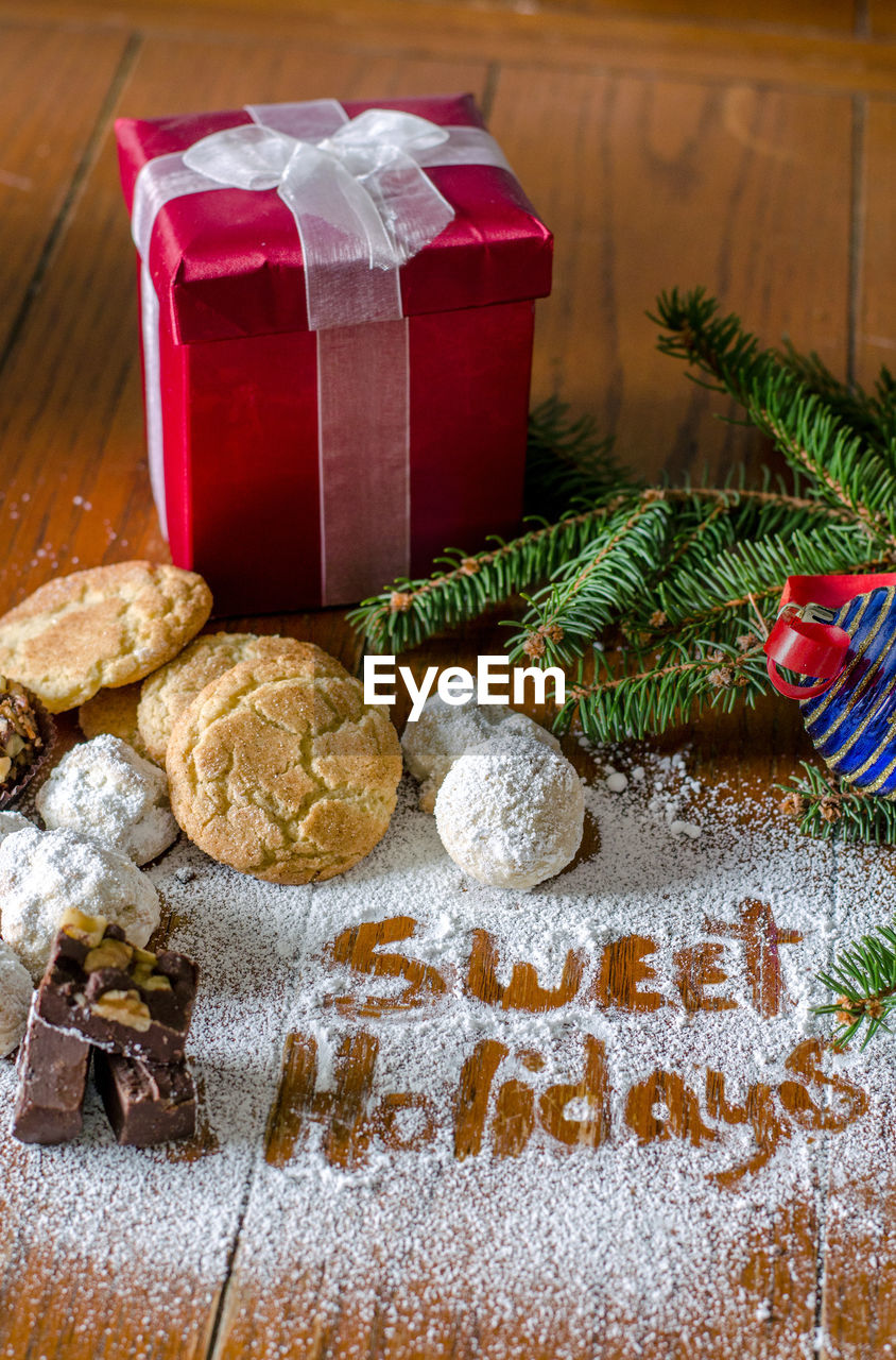 Cookies and package with text written in the spilled sugar, for christmas wishes