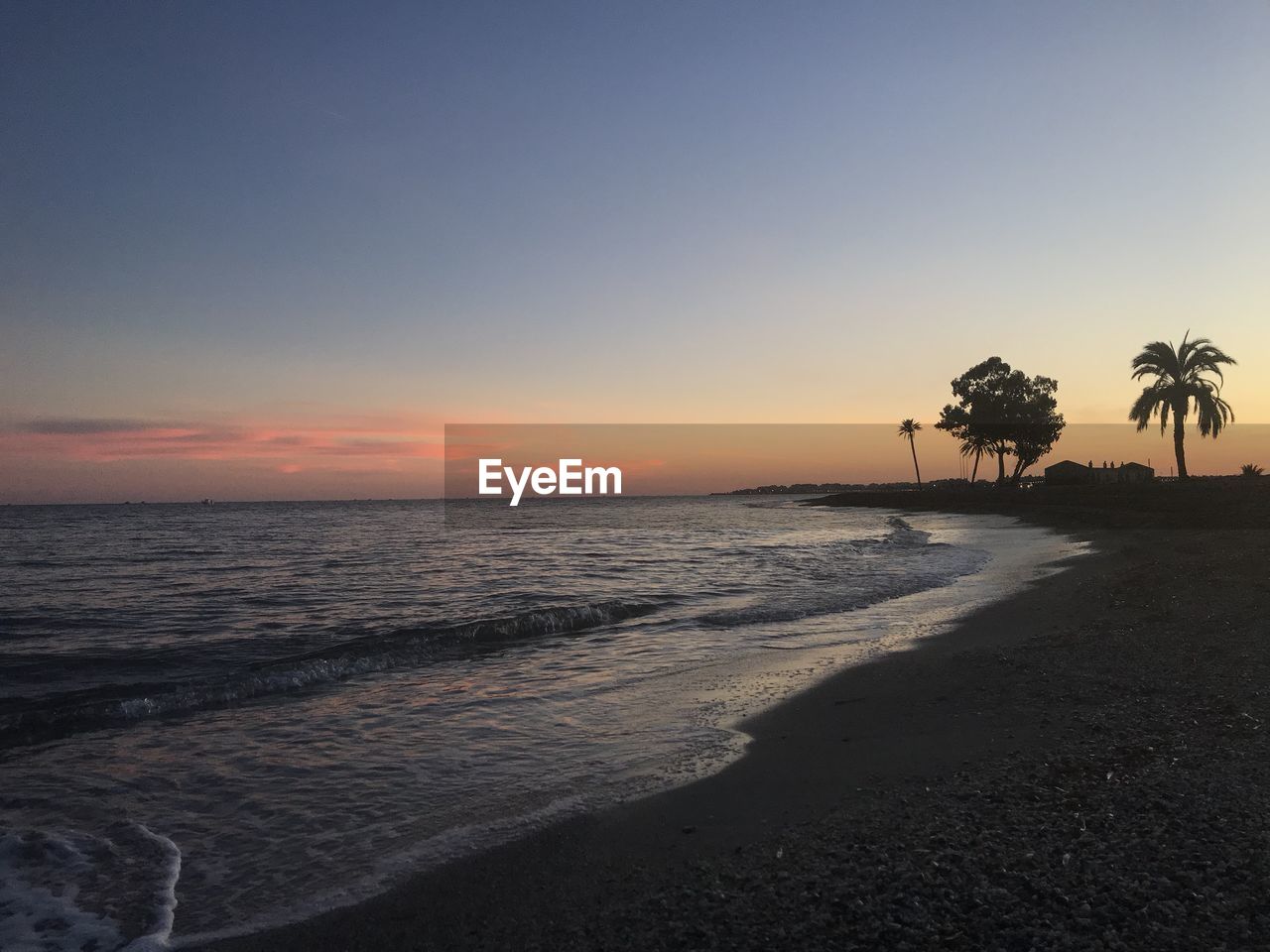 Scenic view of sea against sky at sunset