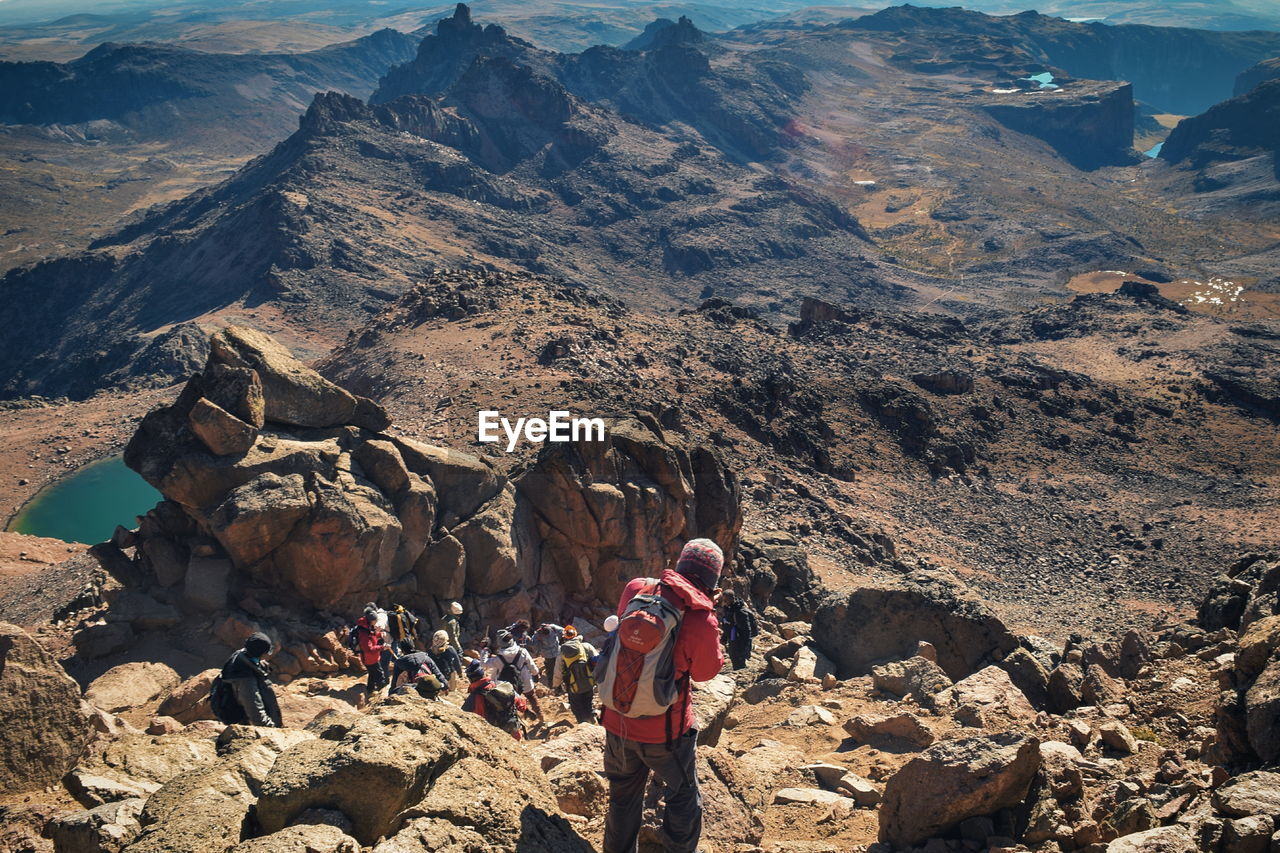 A group of hikers in the panoramic volcanic mountain landscapes of mount kenya, kenya