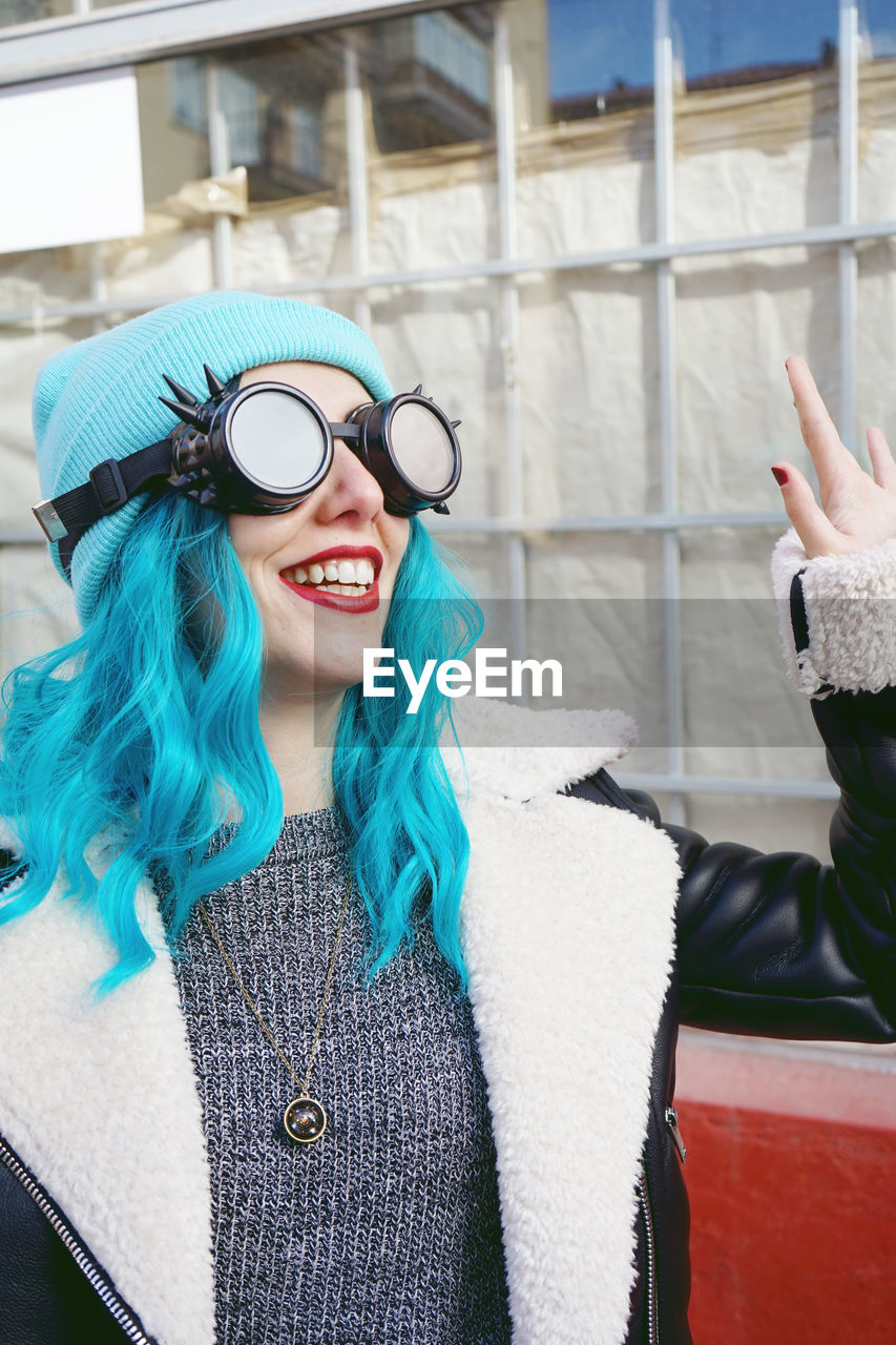 Close-up of fashionable woman with dyed blue hair in city