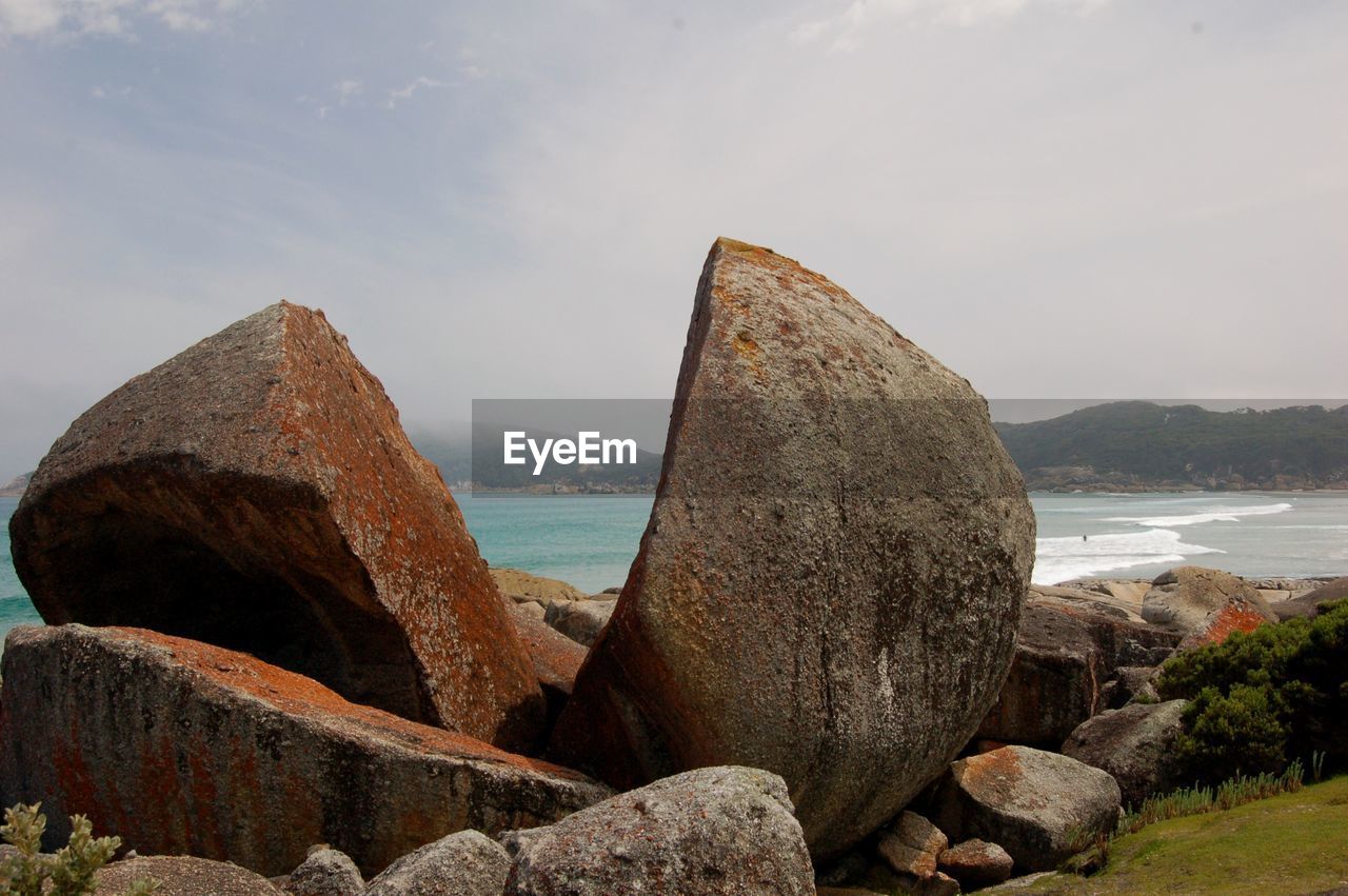 Rocks on beach against sky