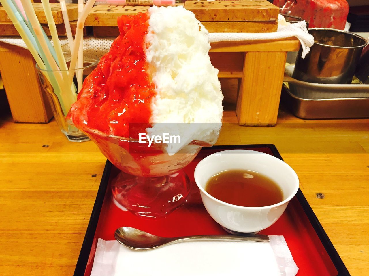 CLOSE-UP OF ICE CREAM WITH JUICE ON TABLE
