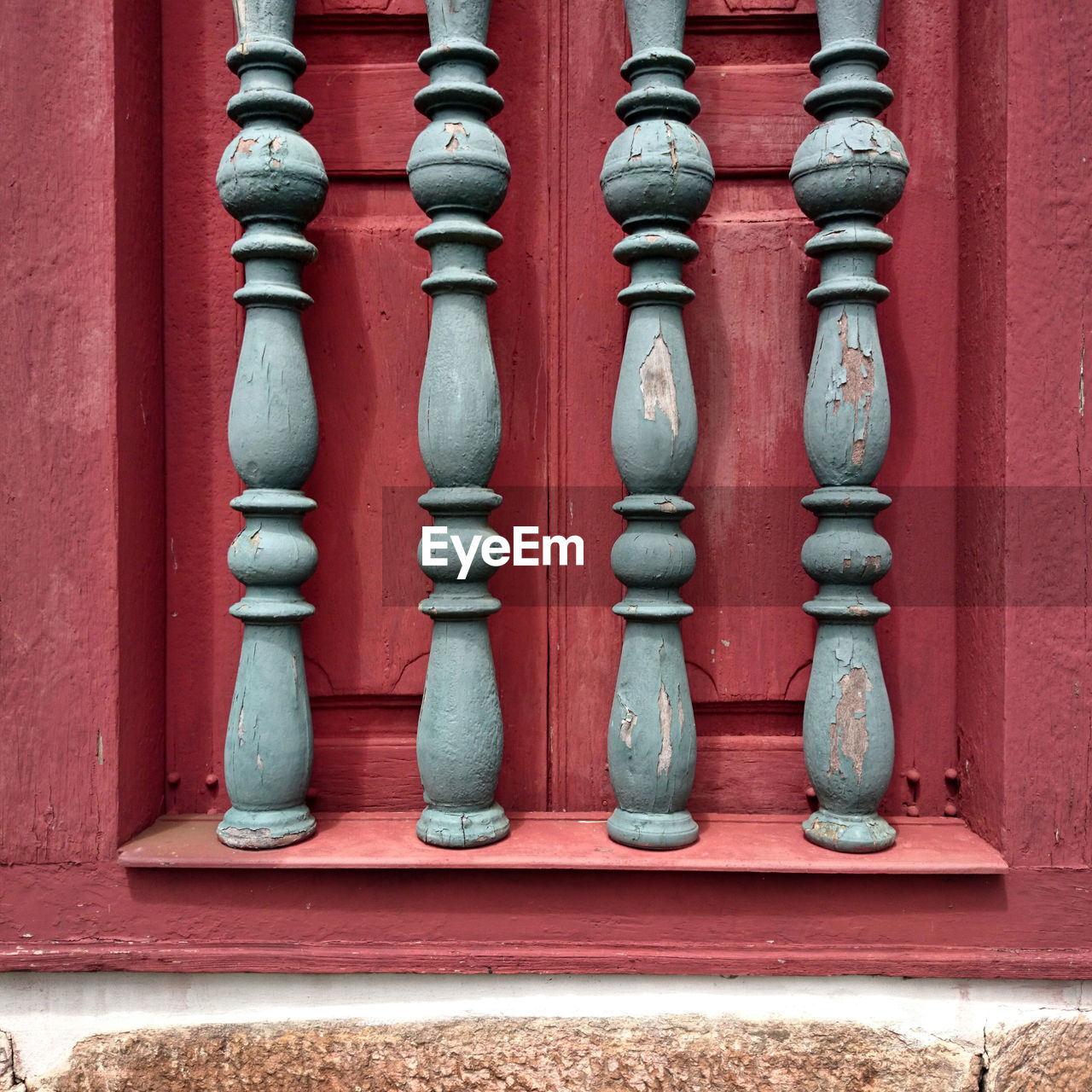 Silver grate on red window