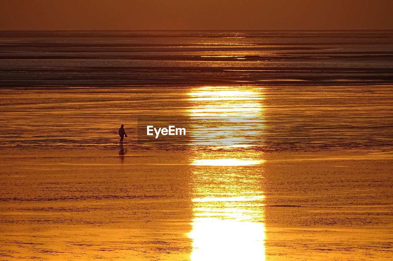 SILHOUETTE PEOPLE ON BEACH DURING SUNSET