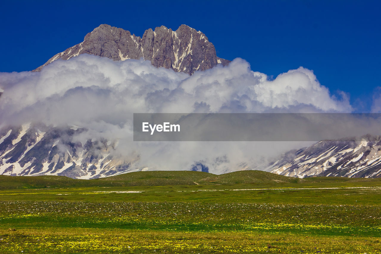 Scenic view of snowcapped mountains against sky