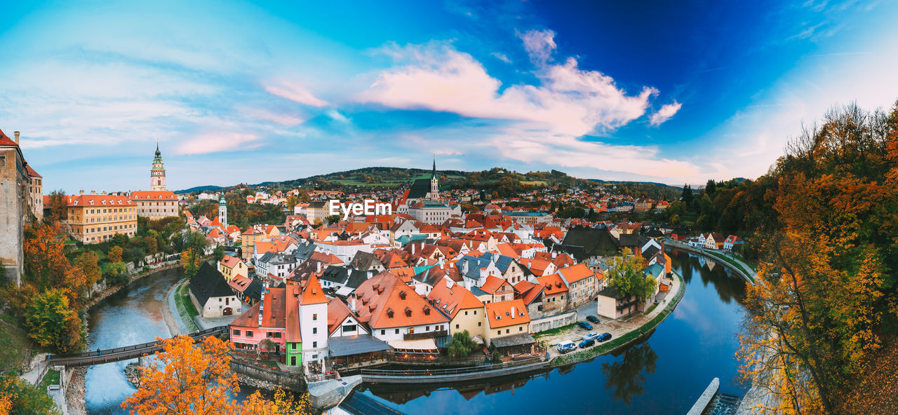 High angle view of townscape by river against sky