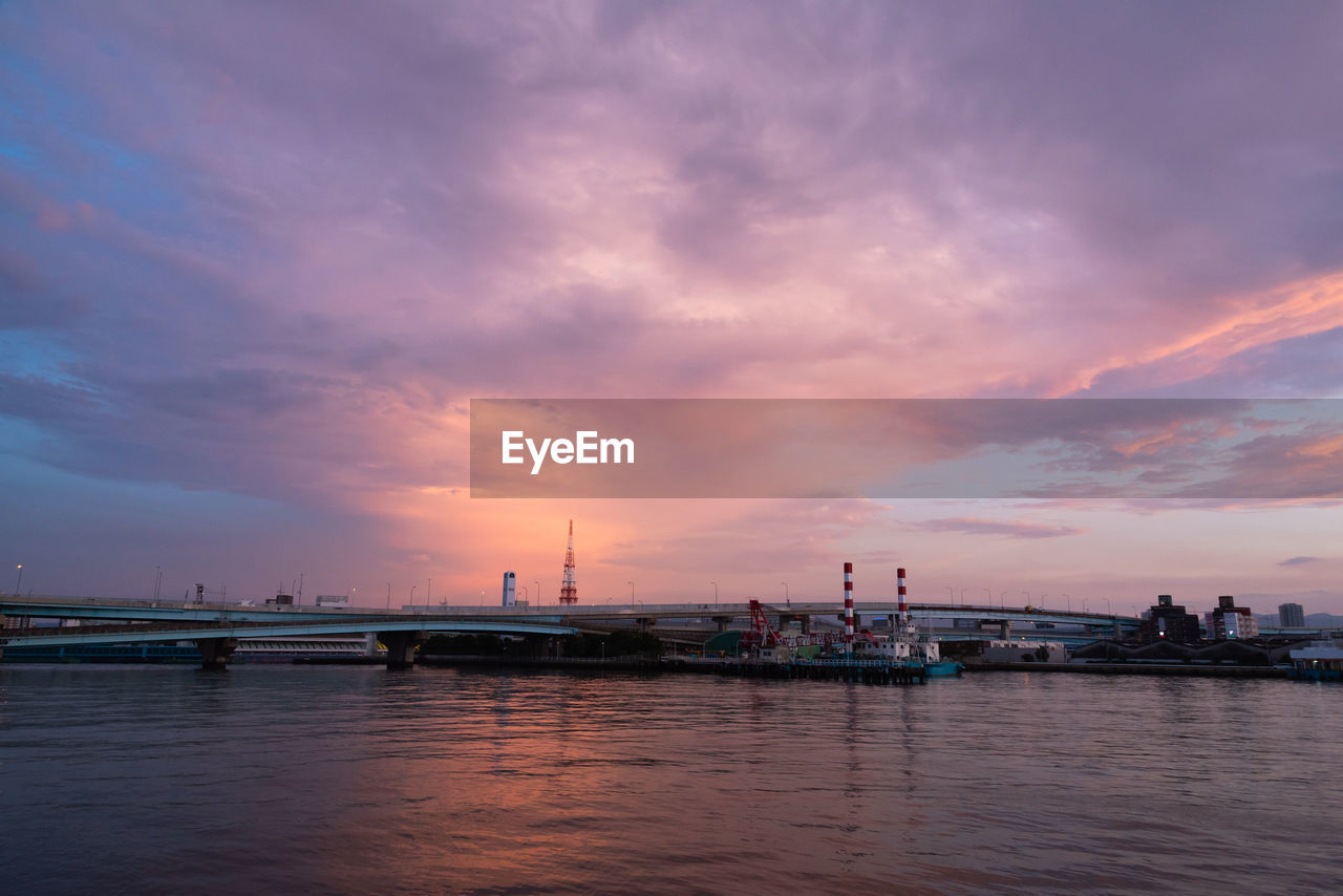 Pier over sea against sky at sunset