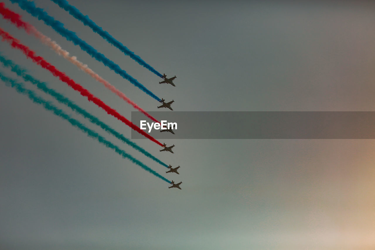 Low angle view of airplane flying against sky