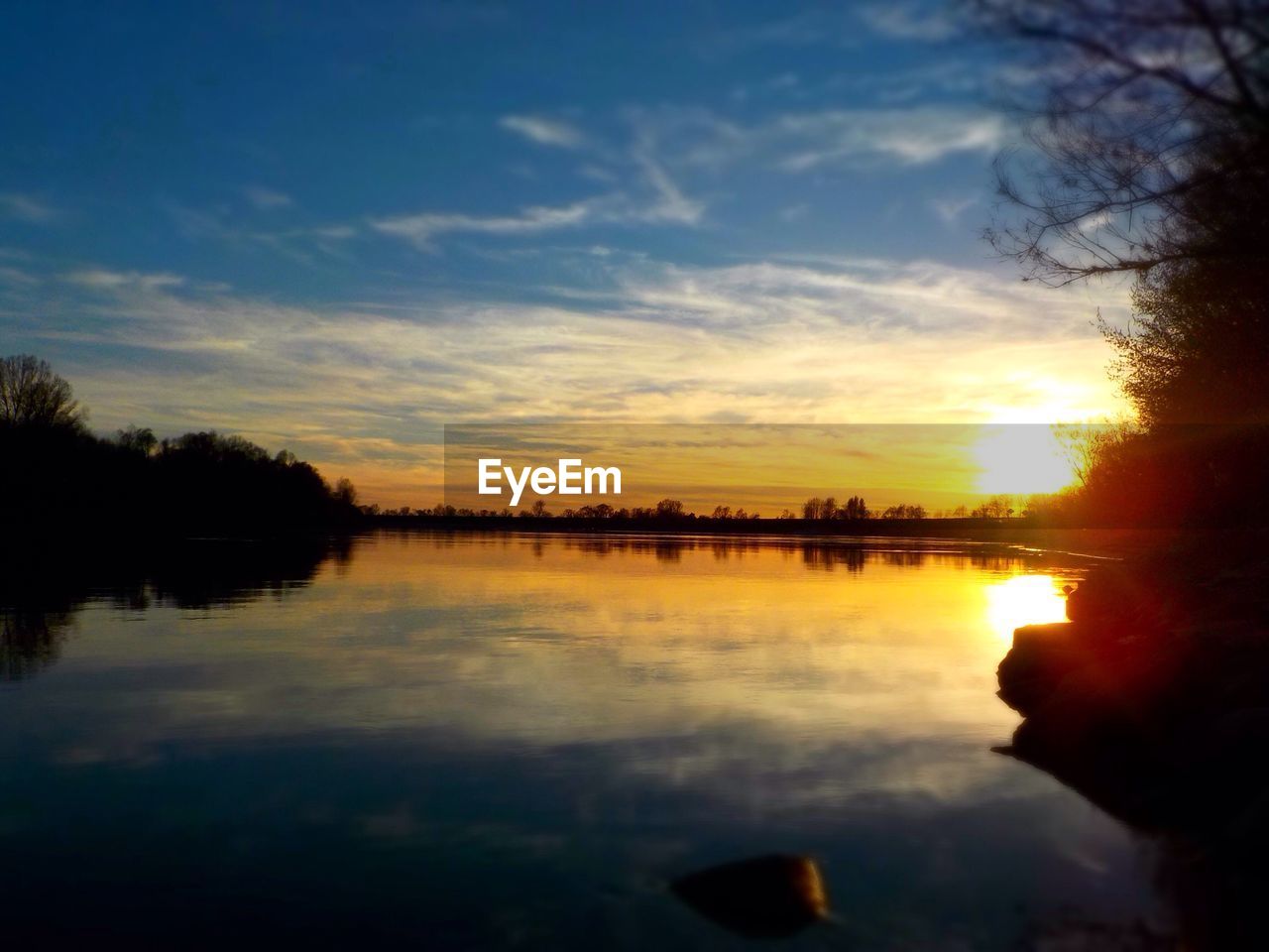 Scenic view of lake against sky during sunset