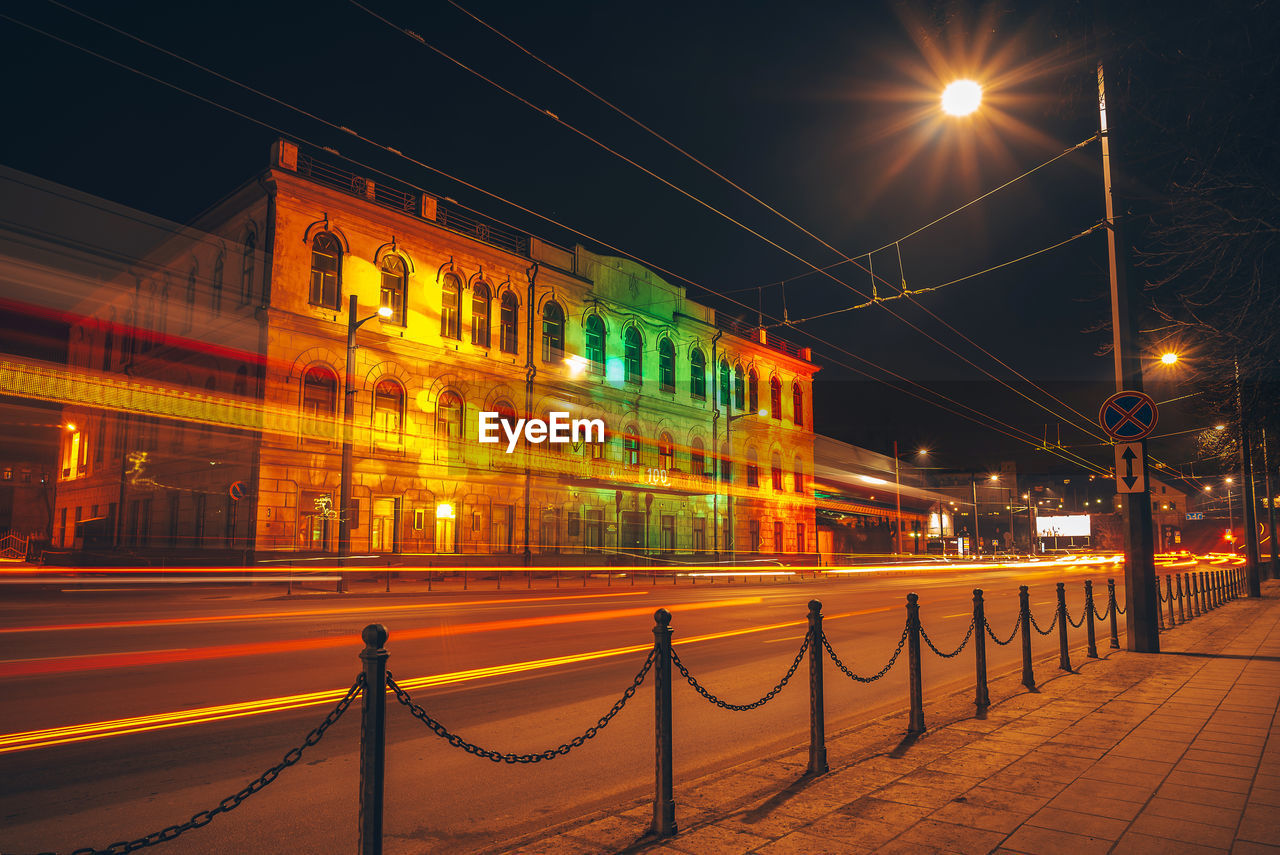 ILLUMINATED STREET LIGHTS ON BRIDGE AT NIGHT