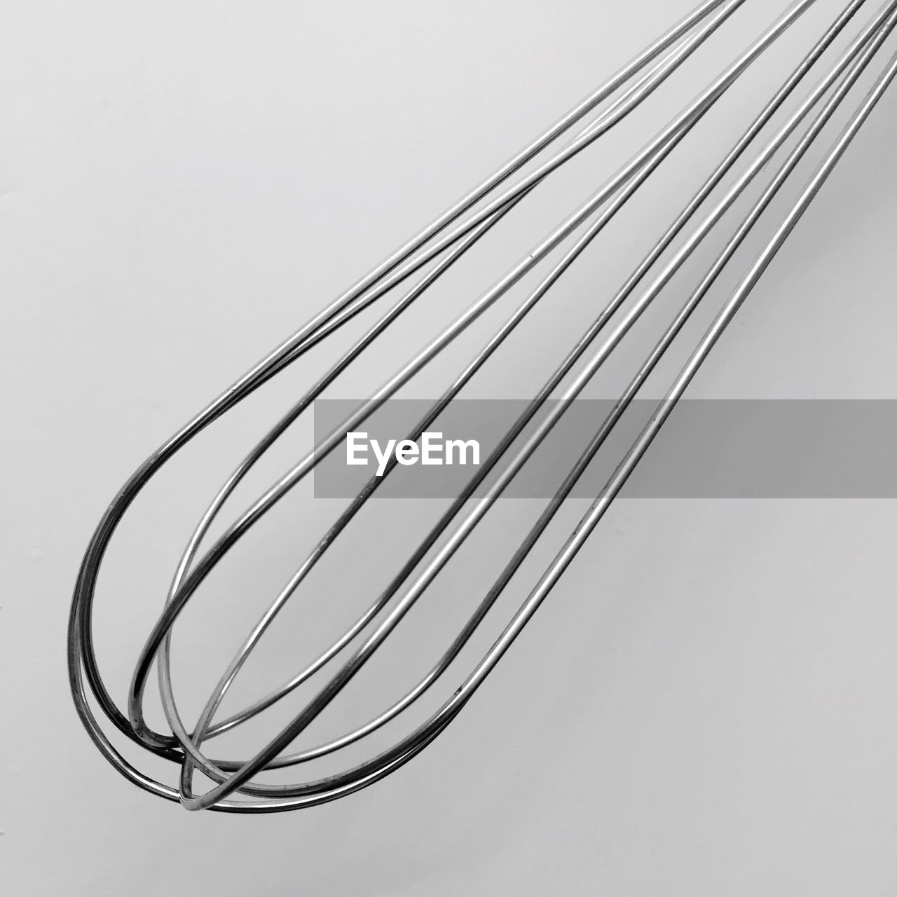 Close-up of wire whisk on white background