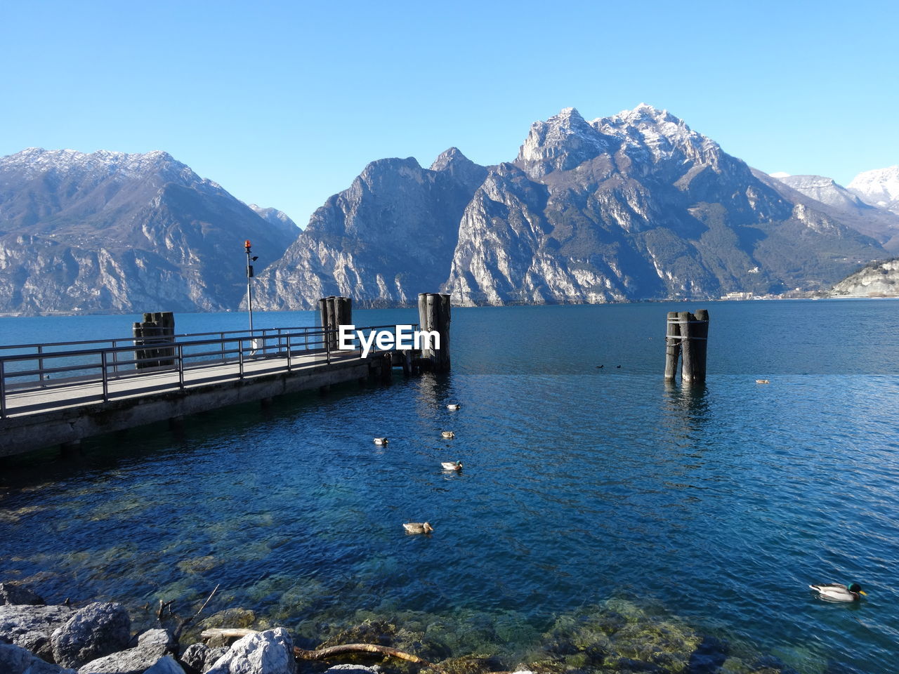 Scenic view of snowcapped mountains against clear blue sky