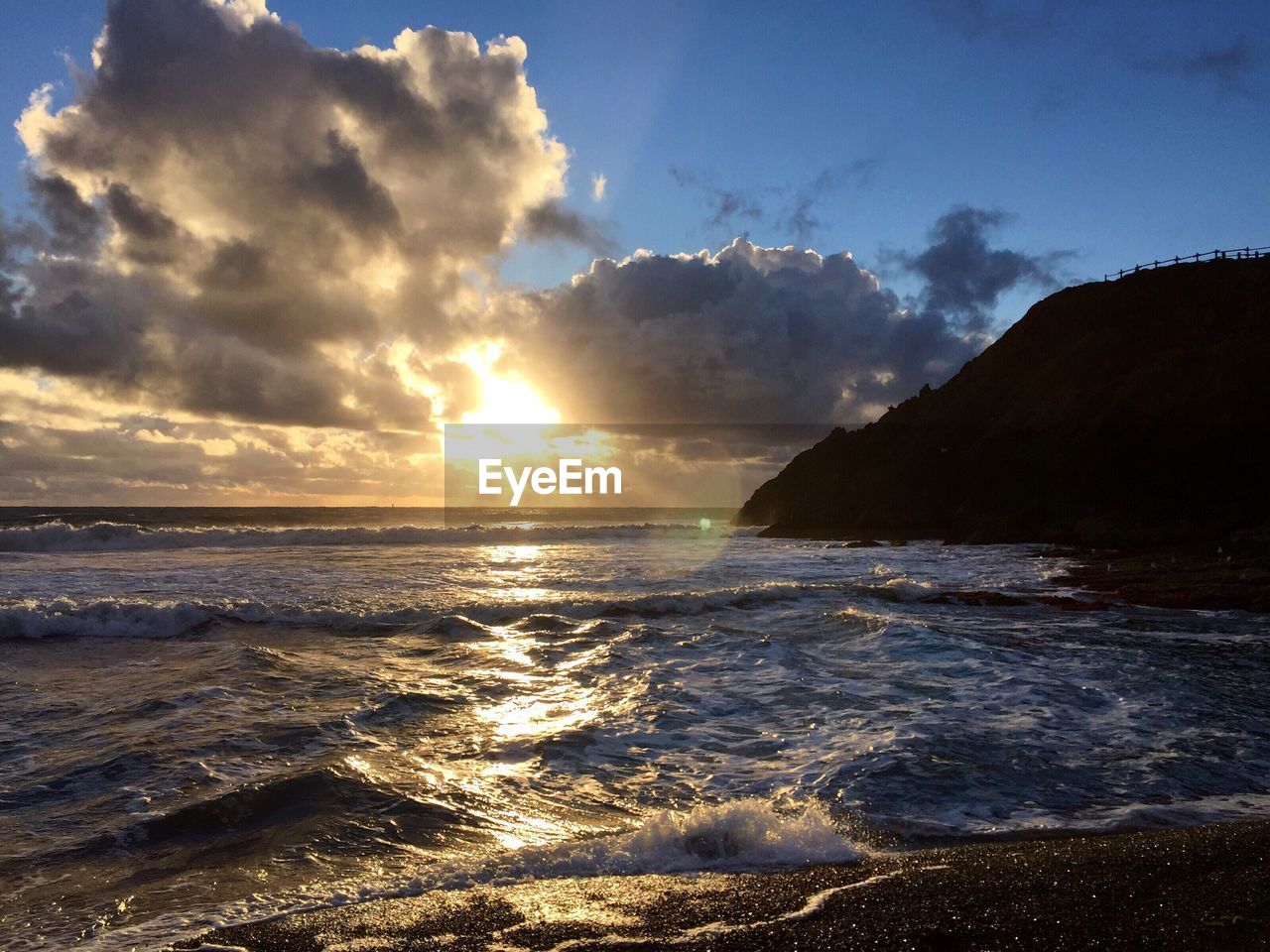 Scenic view of sea against cloudy sky