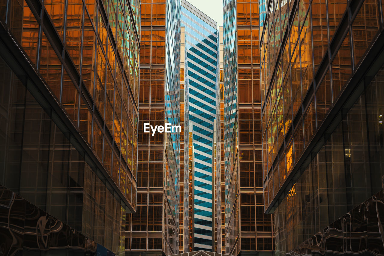 Low angle view of modern glass buildings in city