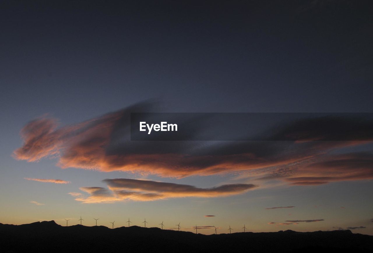 LOW ANGLE VIEW OF DRAMATIC SKY OVER SILHOUETTE LANDSCAPE