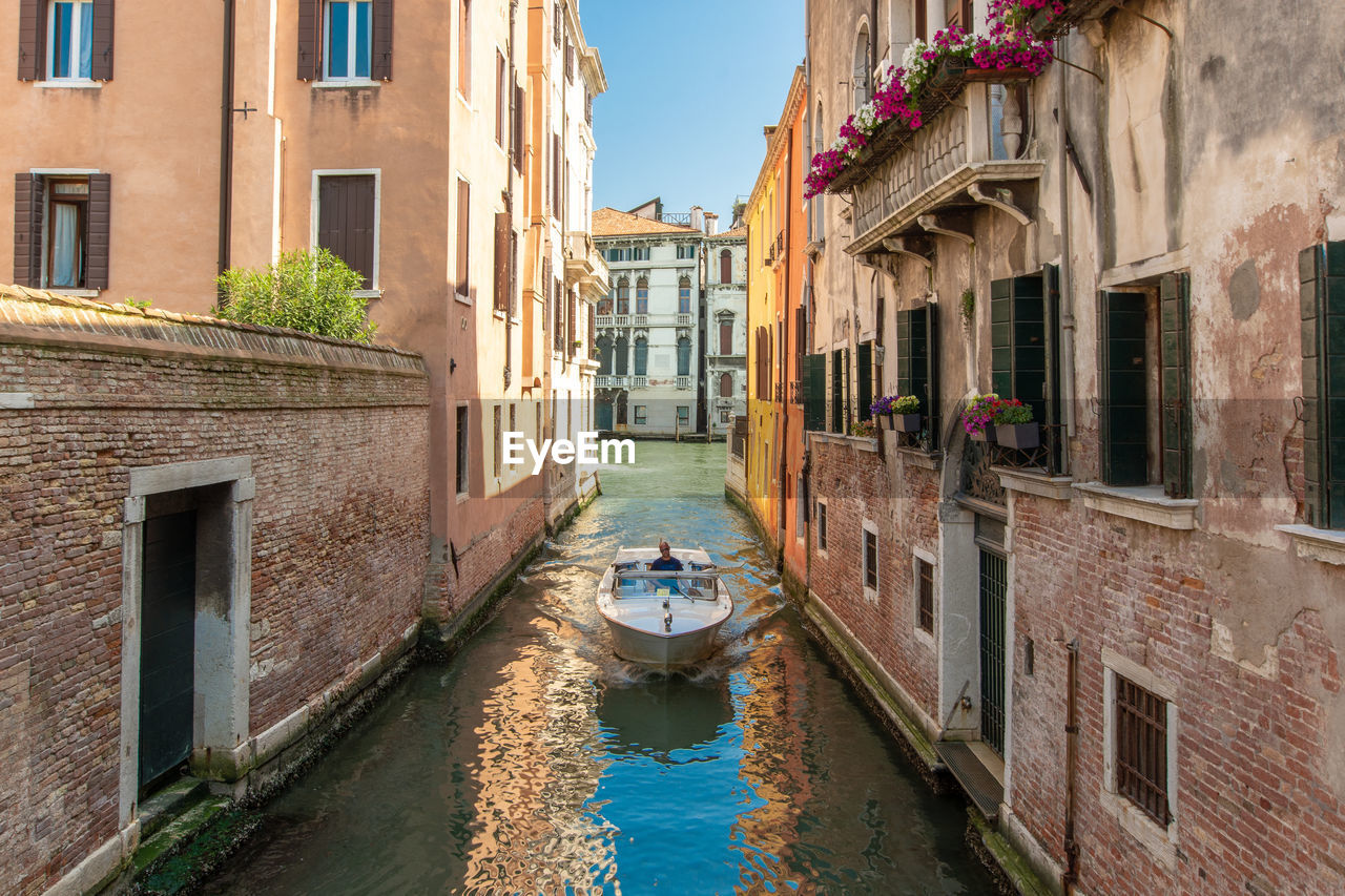 CANAL BY BUILDINGS IN CITY