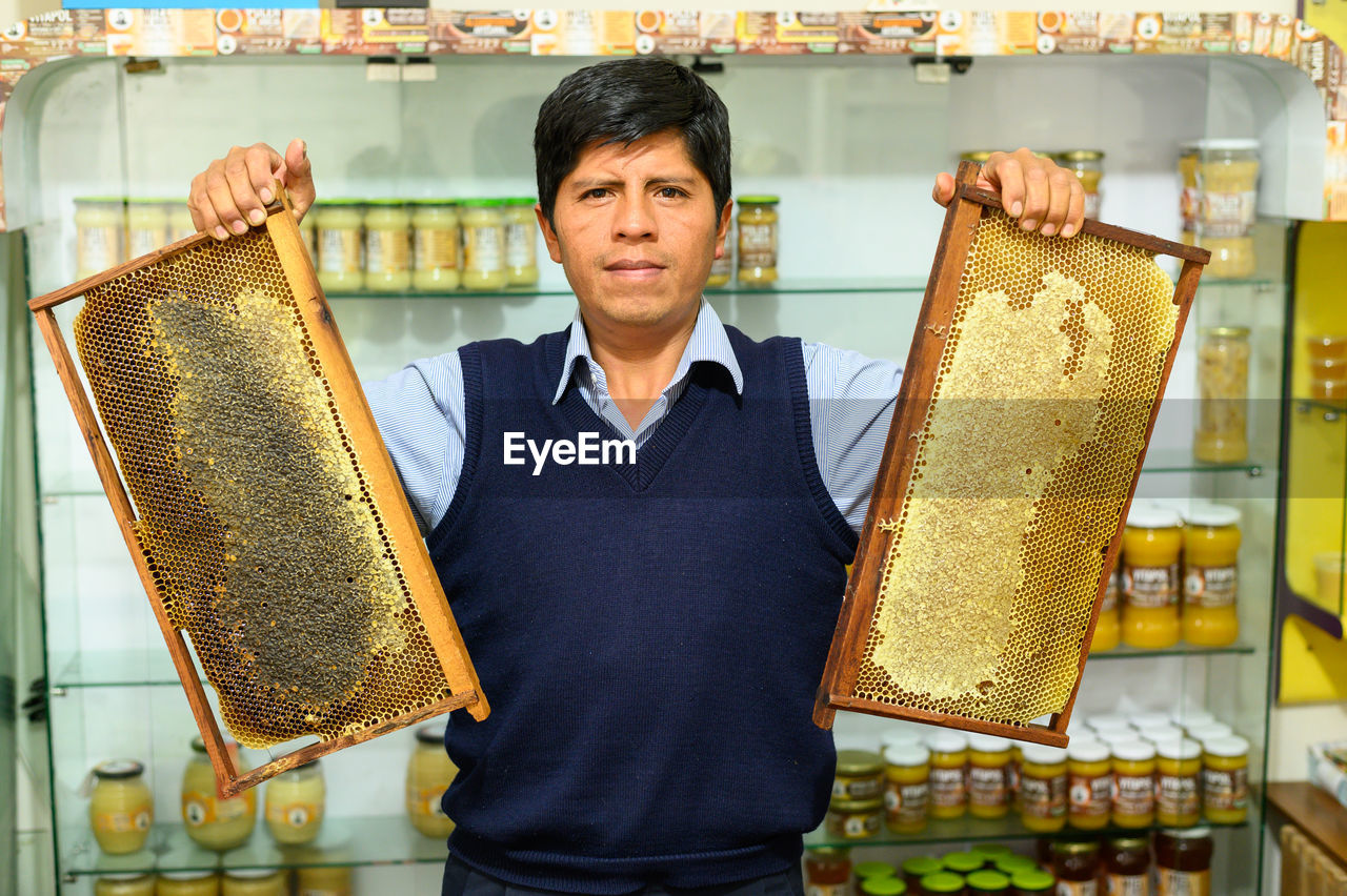 portrait of woman holding food in greenhouse