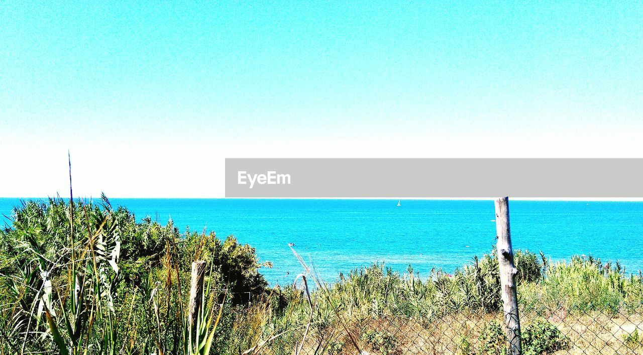 Scenic view of sea against clear blue sky