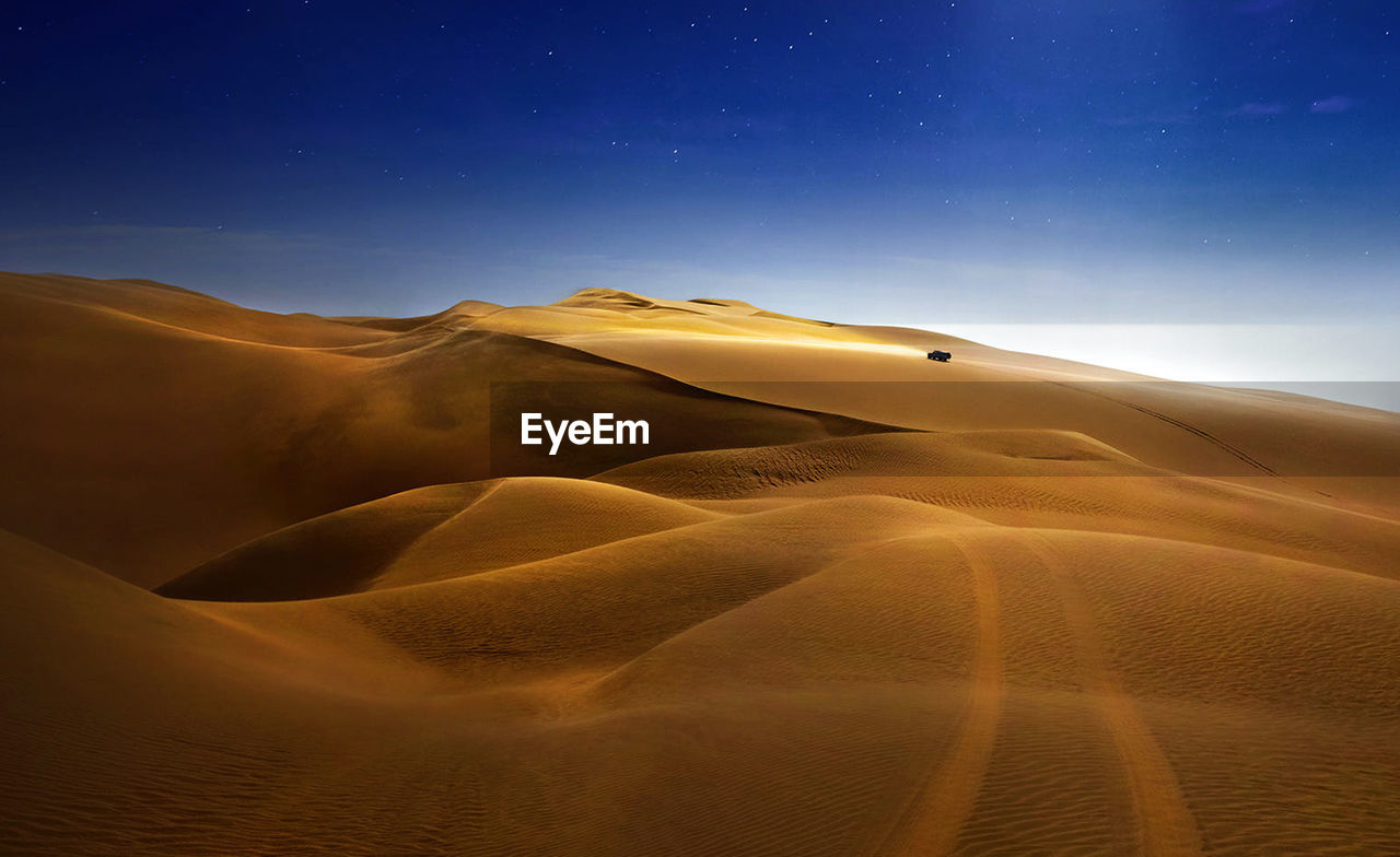 Scenic view of desert against sky at night