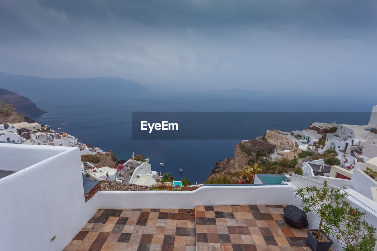 Panorama of the village of oia and the caldera on a rare rainy day, santorini, greece