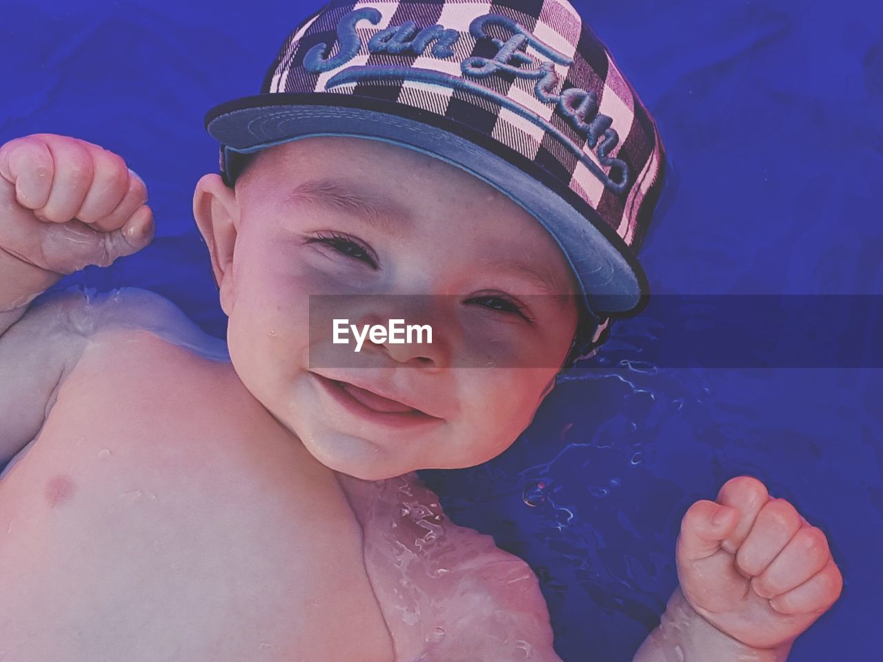 Portrait of cute boy in swimming pool