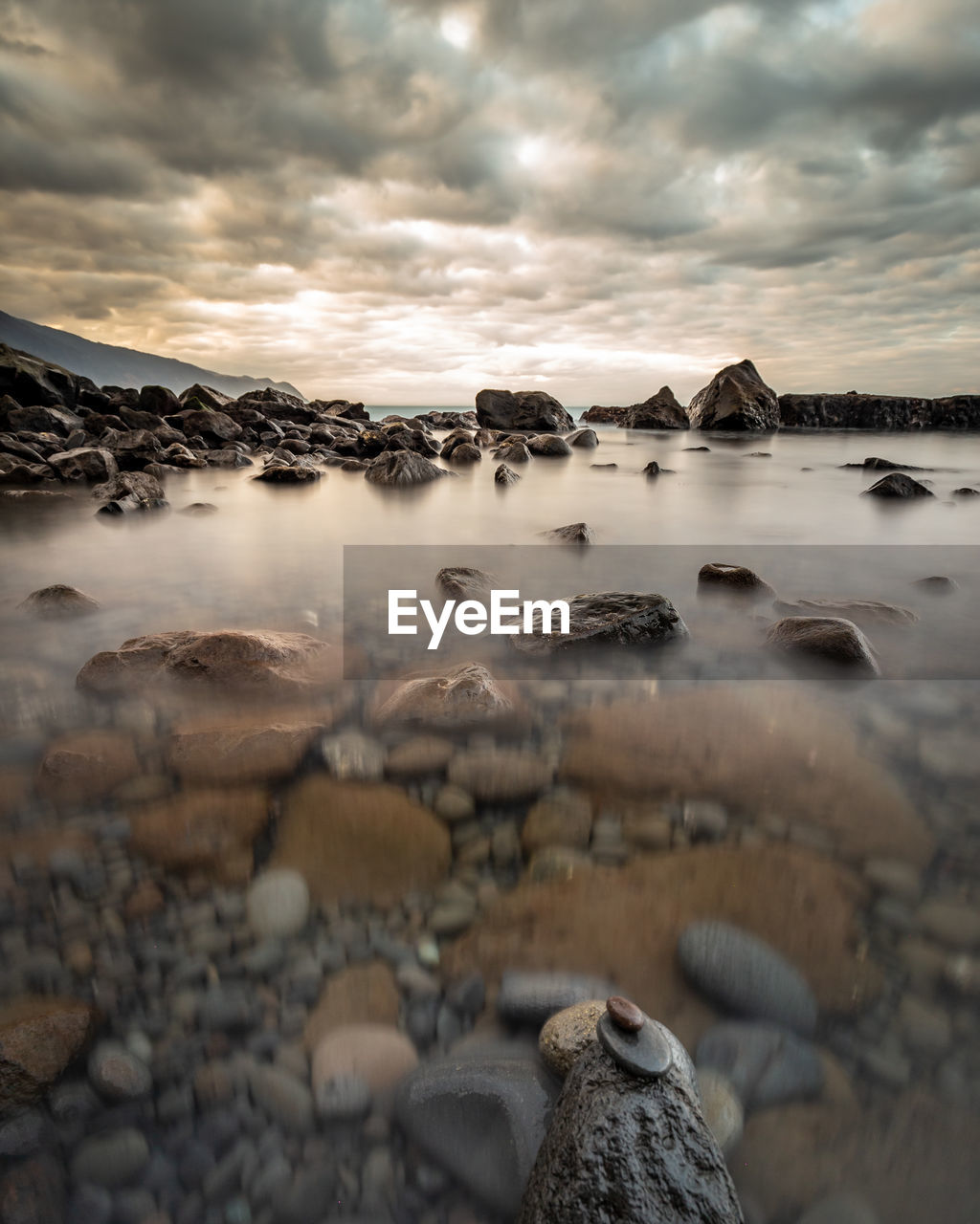 SCENIC VIEW OF ROCKS IN SEA AGAINST SKY