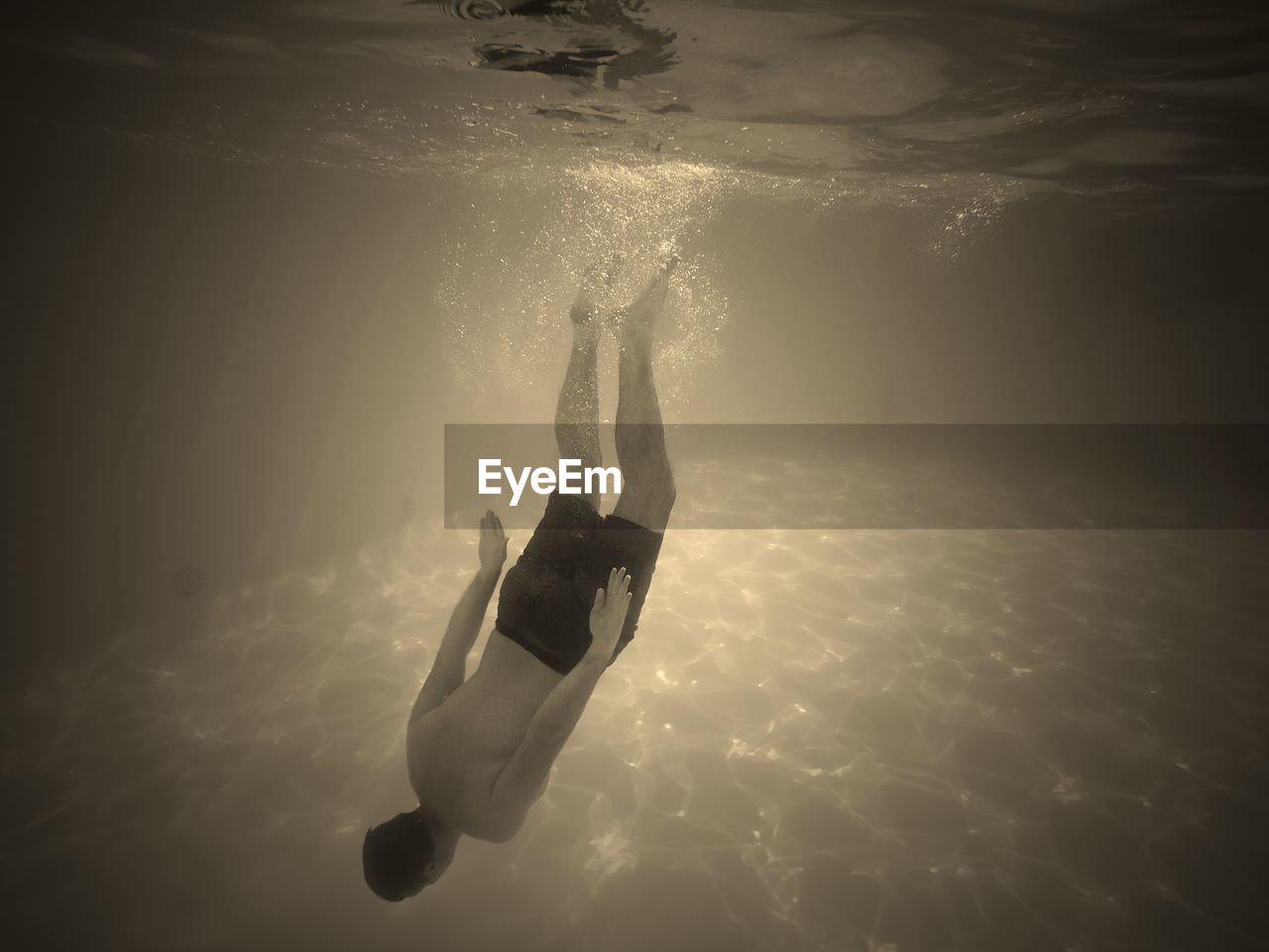 MAN SWIMMING IN SEA