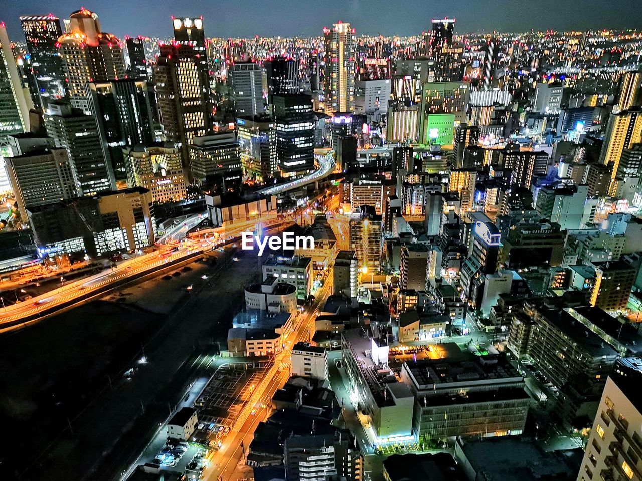 High angle view of illuminated street amidst buildings in city