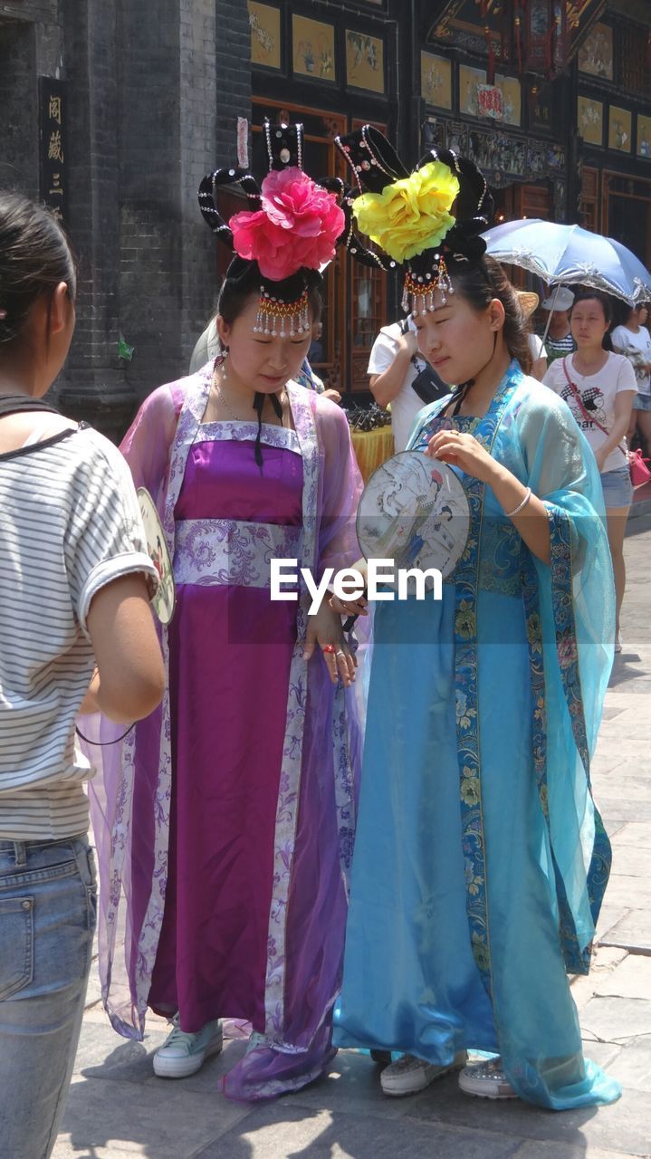 GROUP OF PEOPLE IN TRADITIONAL CLOTHING