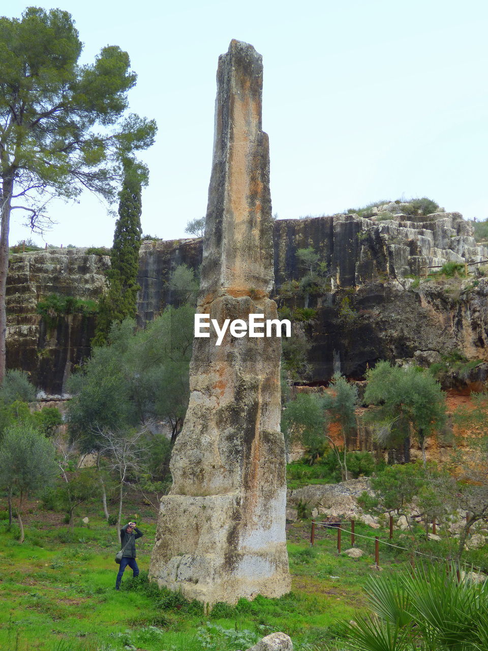 Full length of person standing at historic place against sky